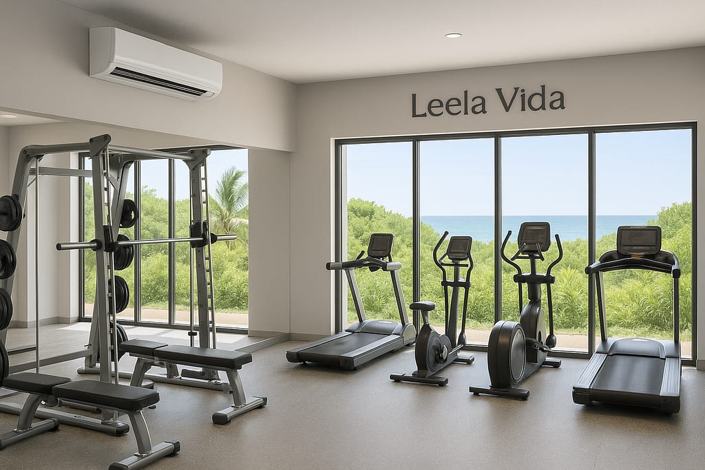 Interior of The Leela Vida Oceanfront Gym with AC unit, vegetation outside the windows, and ocean in the distance.