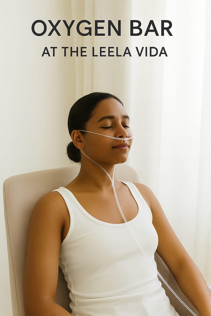 A young Caribbean woman with light brown skin relaxes during an oxygen therapy session at The Leela Vida, seated comfortably with a nasal cannula in a calm wellness setting.